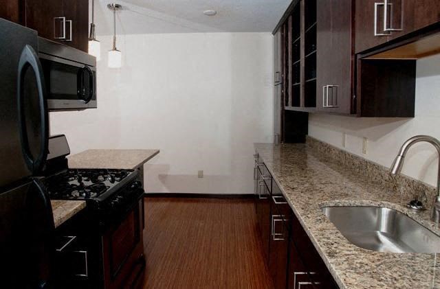 a kitchen with granite counter tops and a sink
