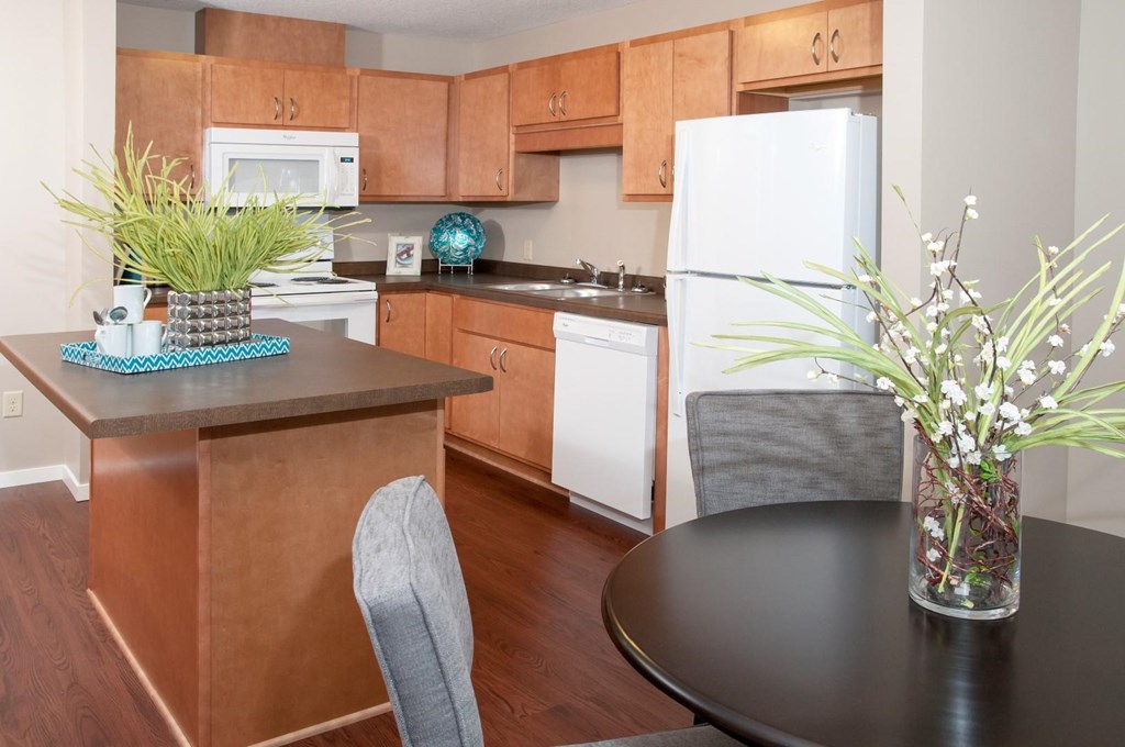 a kitchen and dining area with a table and chairs