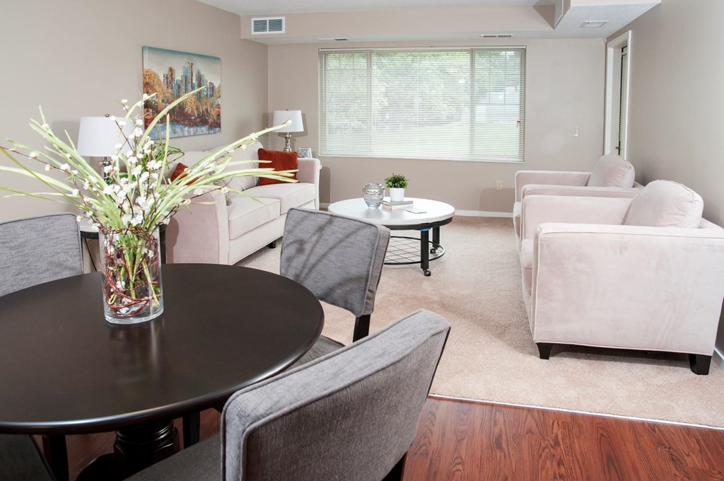 a living room with couches and chairs and a table