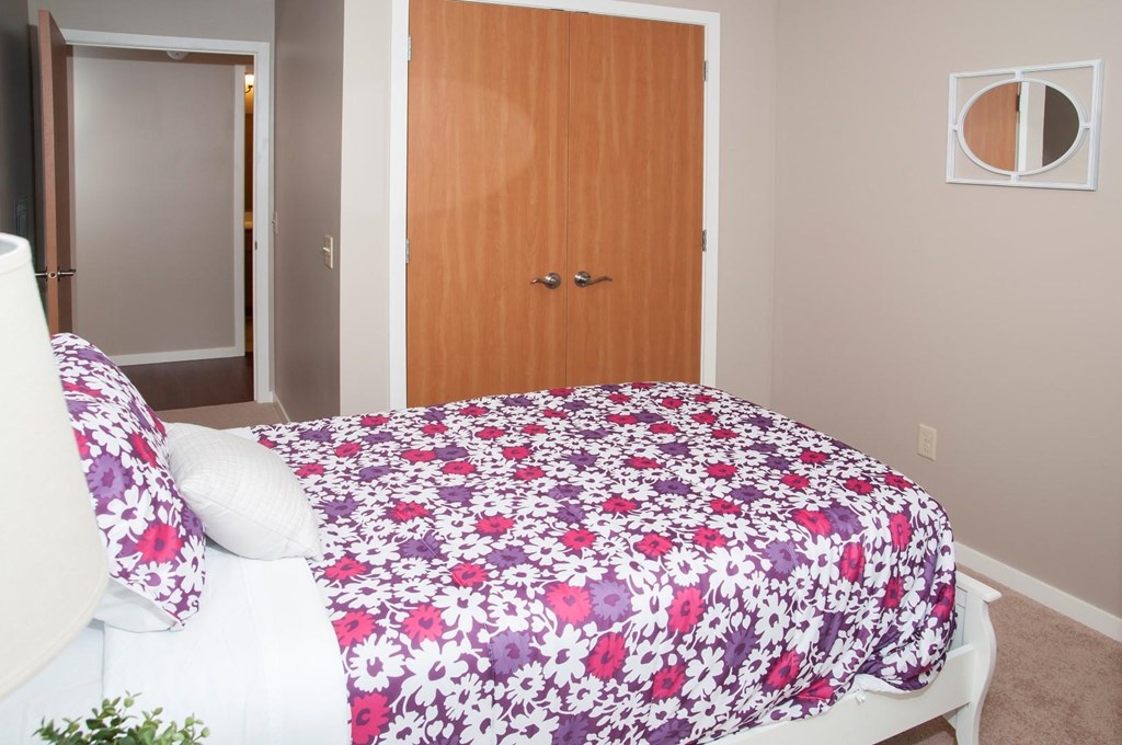 a bedroom with a bed and a wooden door