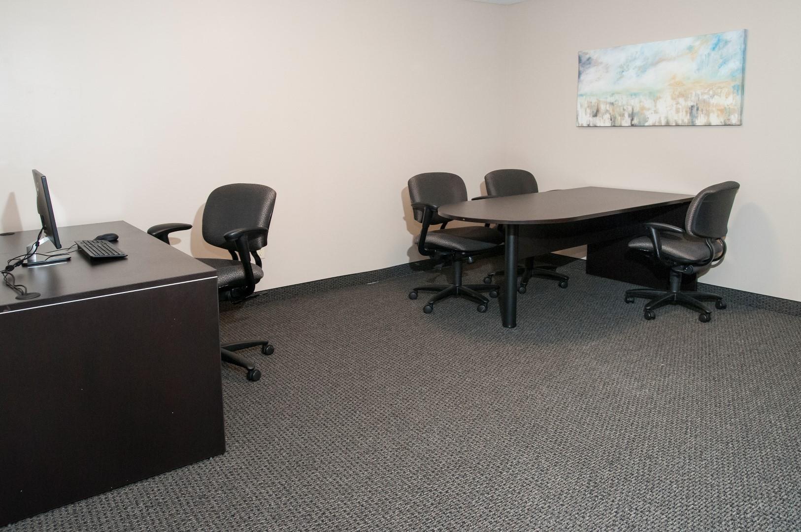 Office Space with Office Chairs, Work Tables and Computers at Compass Pointe in New Hope, MN