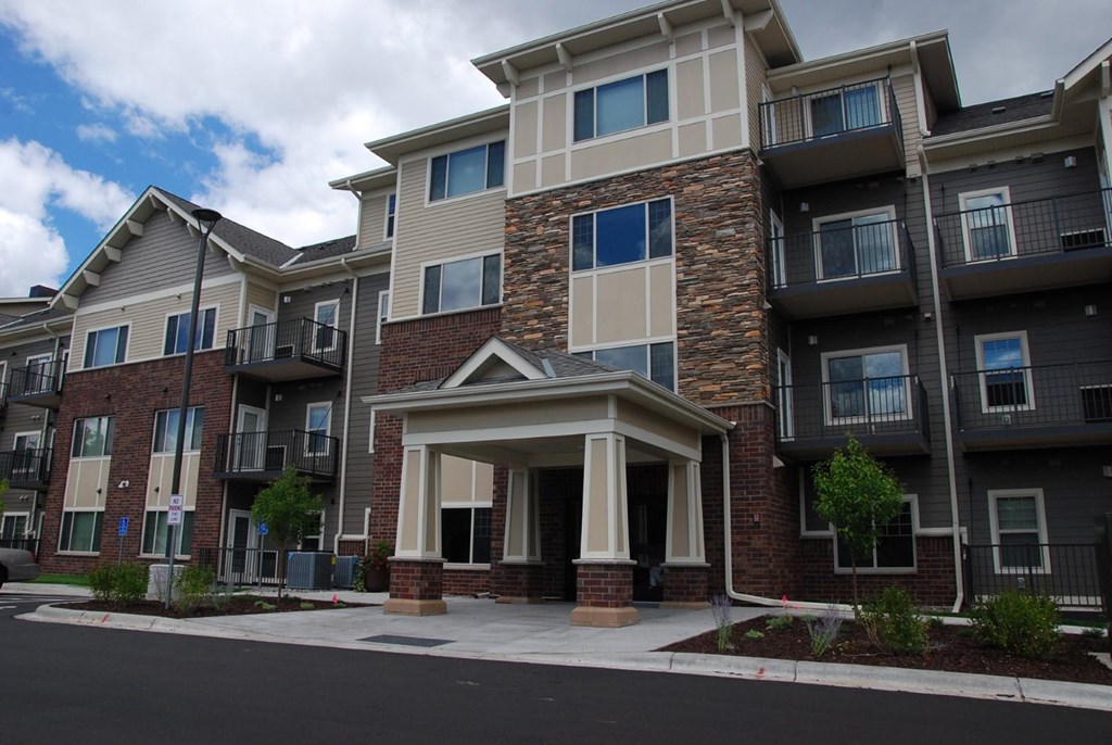 front view of an apartment building with a porch