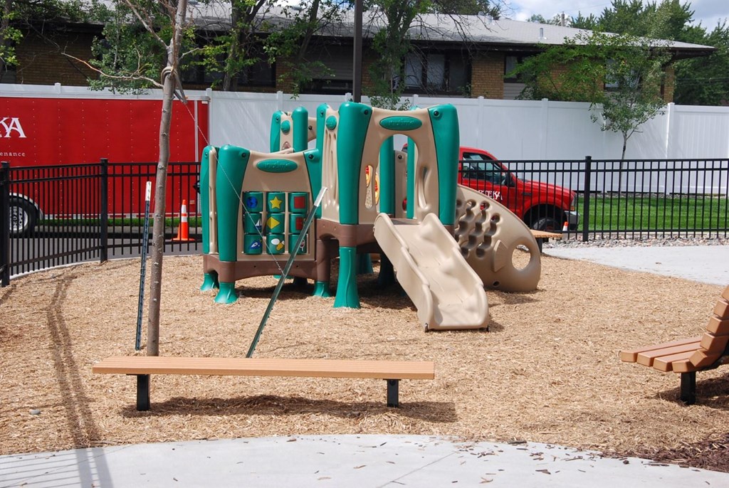 a playground with slides and a bench