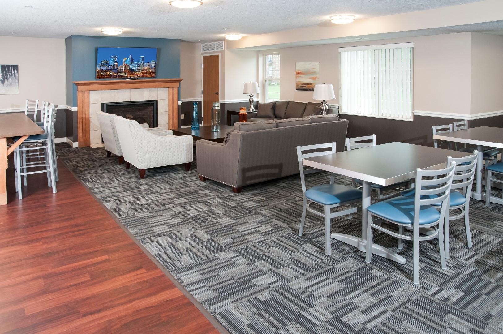 Compass Pointe Apartments Community Space with Large Couches and Kitchen Tables