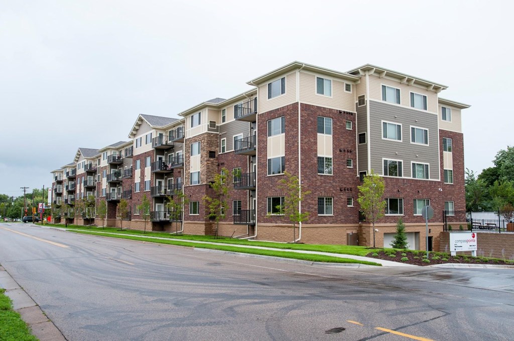 an empty street in front of an apartment building
