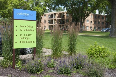 a sign in front of an apartment building