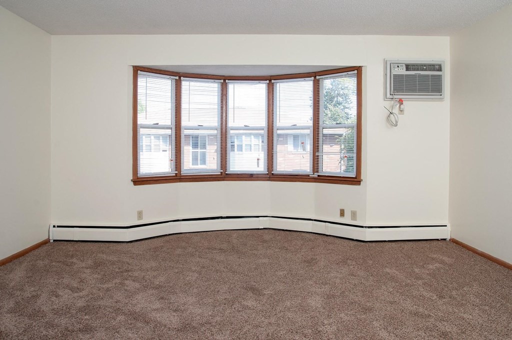 living room with carpeting and large bay window