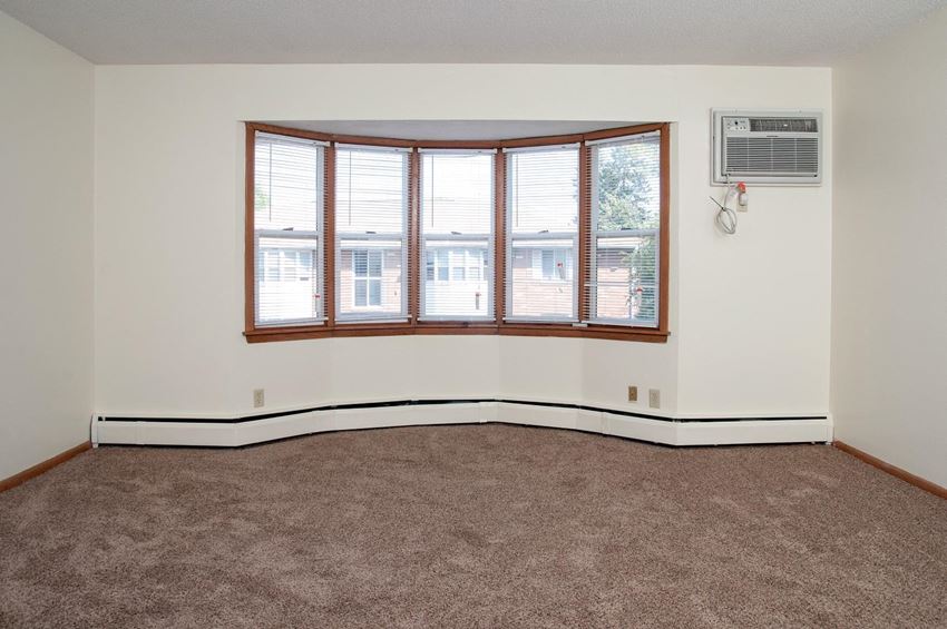 living room with carpeting and large bay window - Photo Gallery