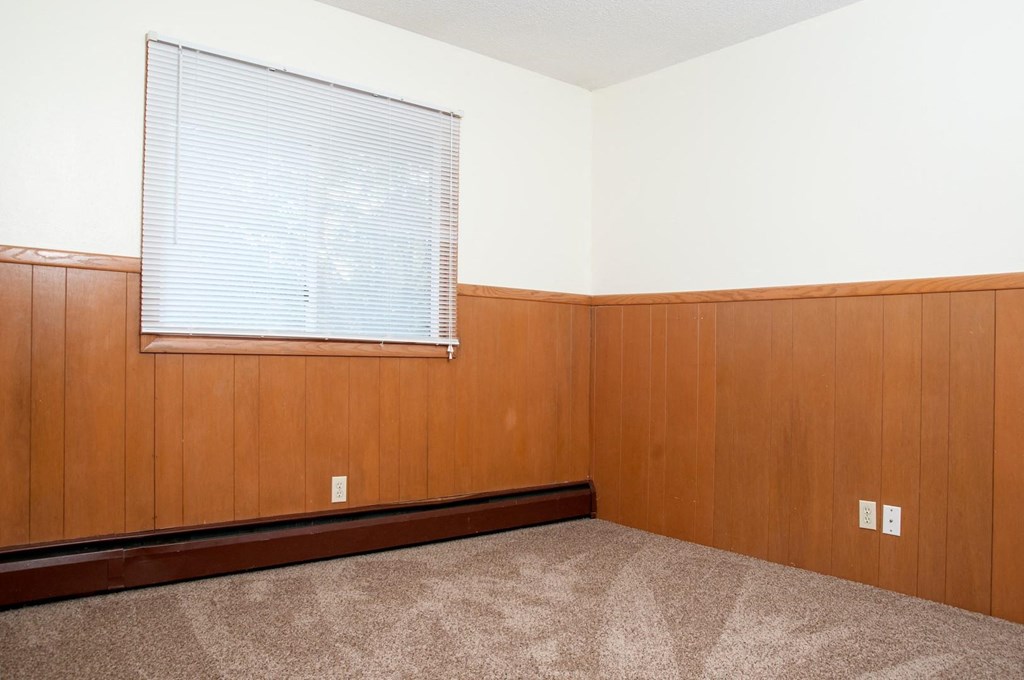 bedroom with carpeting a window for natural light with window coverings
