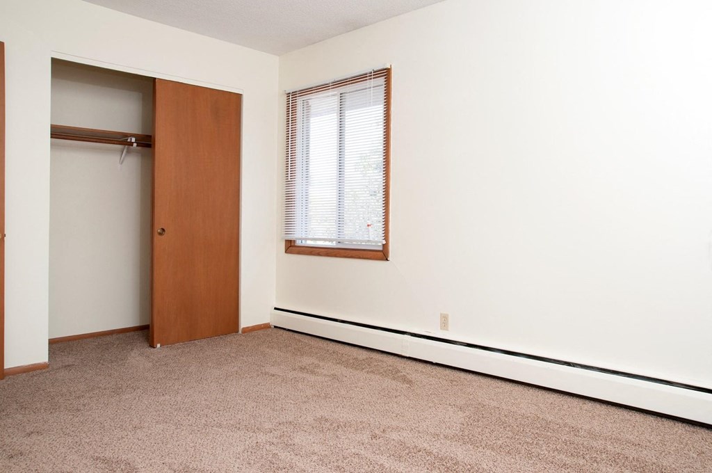Bedroom with closet and window and carpeting