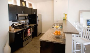 Kitchen Bar With Granite Counter Top at Urban Park Apartments, St Louis Park, 55426