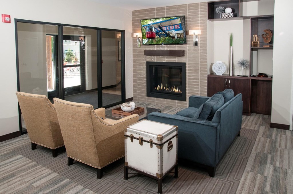 a living room with a couch and chairs and a fireplace