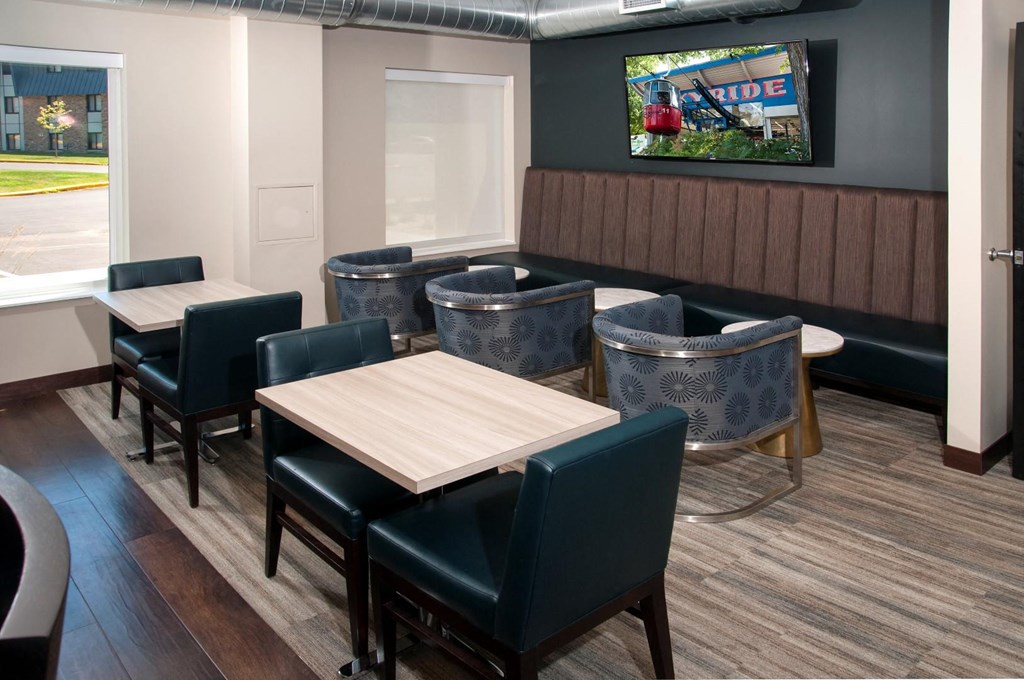 a dining room with tables and chairs and a tv