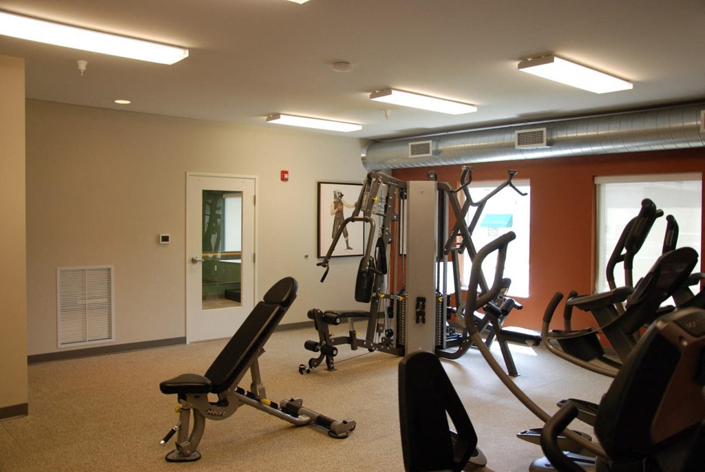 a gym with weights and other equipment in a basement
