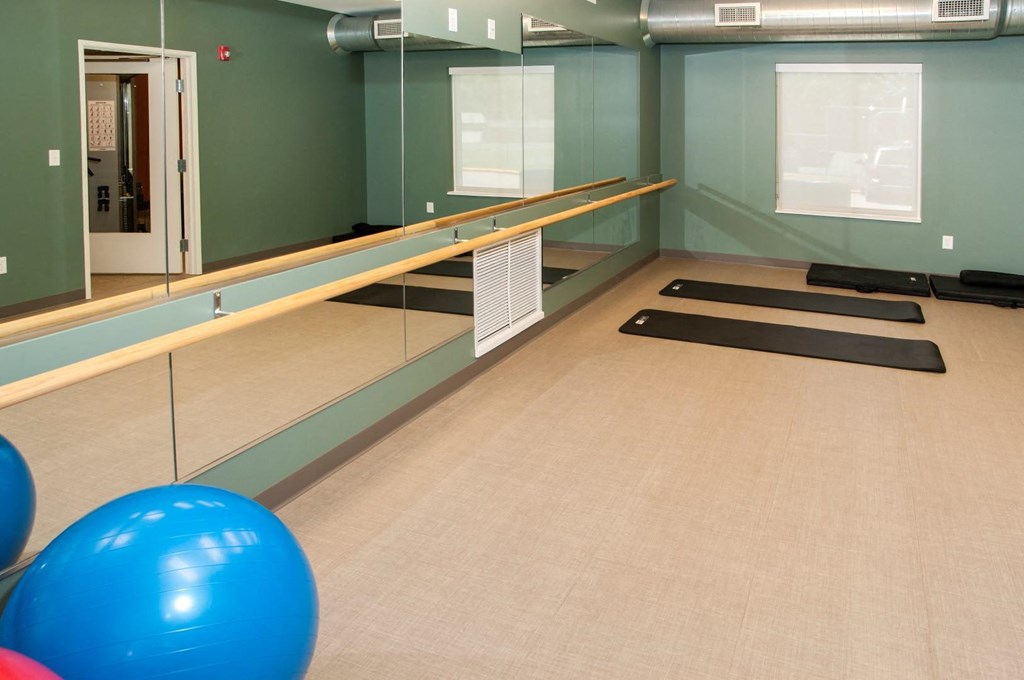 a bowling alley with balls on the floor and mirrors