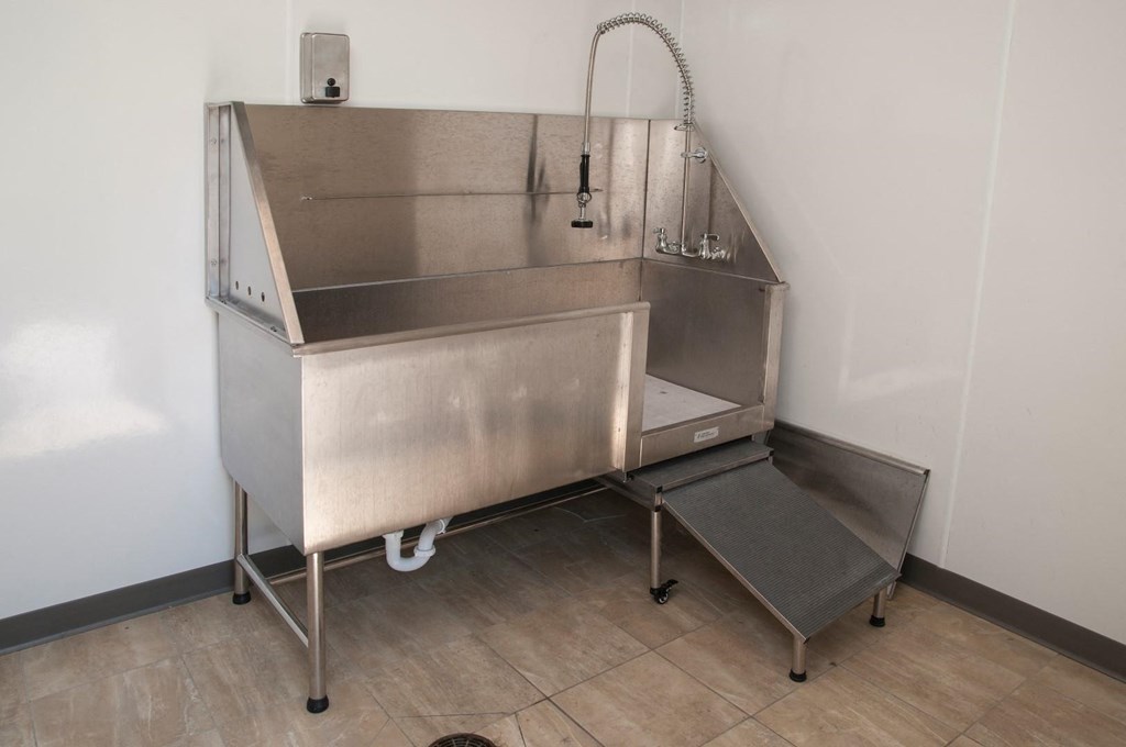 a stainless steel sink in the corner of a room