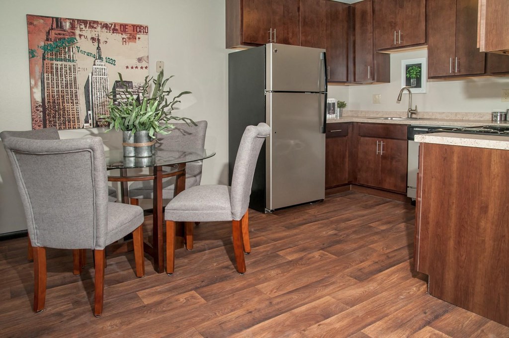 a kitchen with a table and chairs and a refrigerator