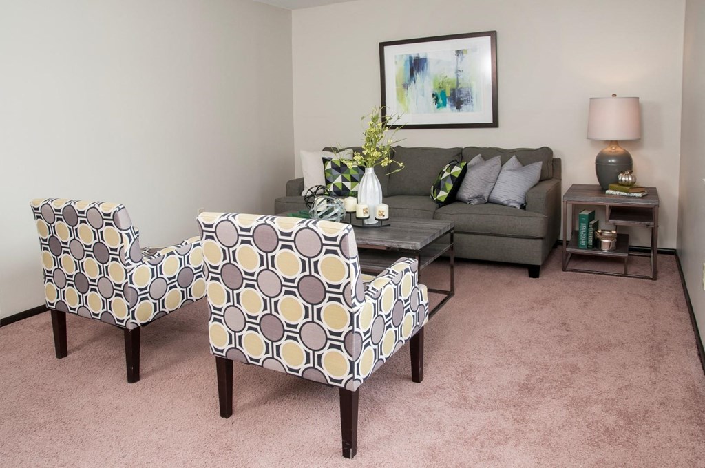 a living room with two chairs and a couch