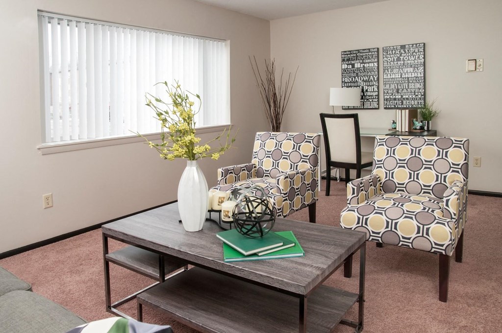 a living room with a table and chairs