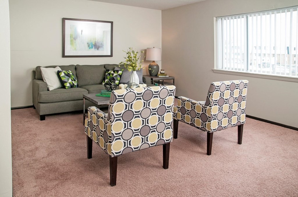 a living room with two chairs and a couch