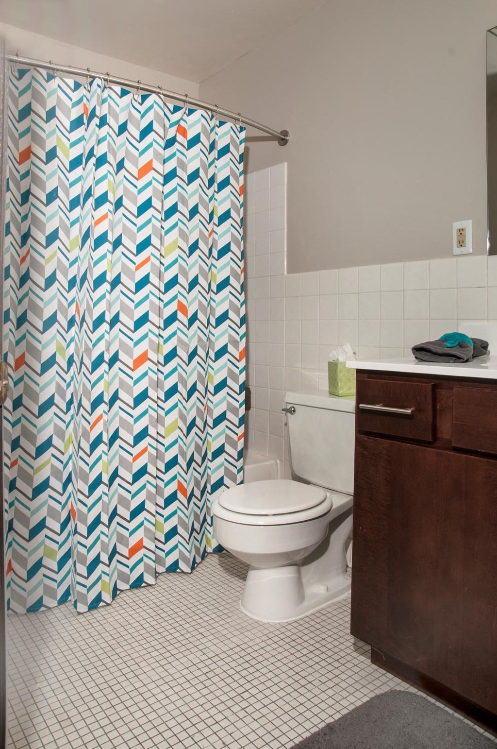 a bathroom with a shower curtain and a toilet