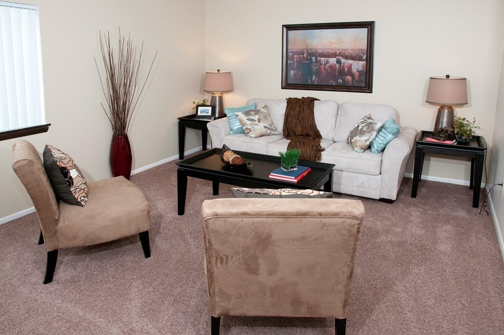 a living room with a couch and chairs