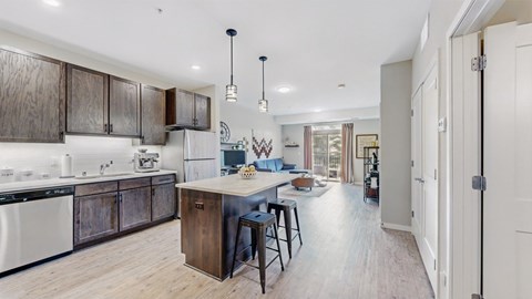 A modern kitchen with dark wood cabinets and white appliances.