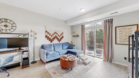 A living room with a blue couch and a wooden coffee table.