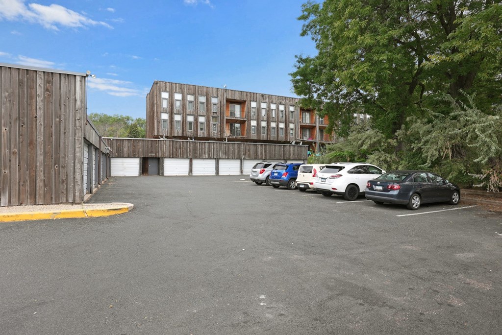 a parking lot with cars in front of a building