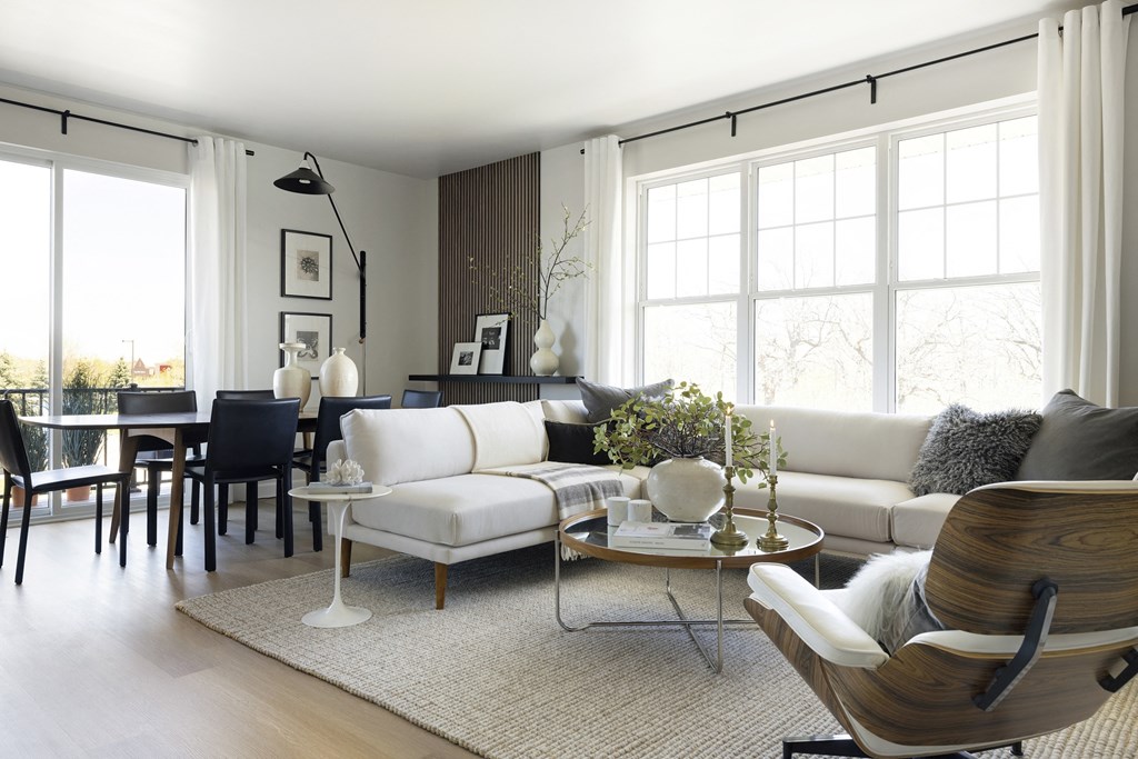 a living room with a white couch and a dining room table