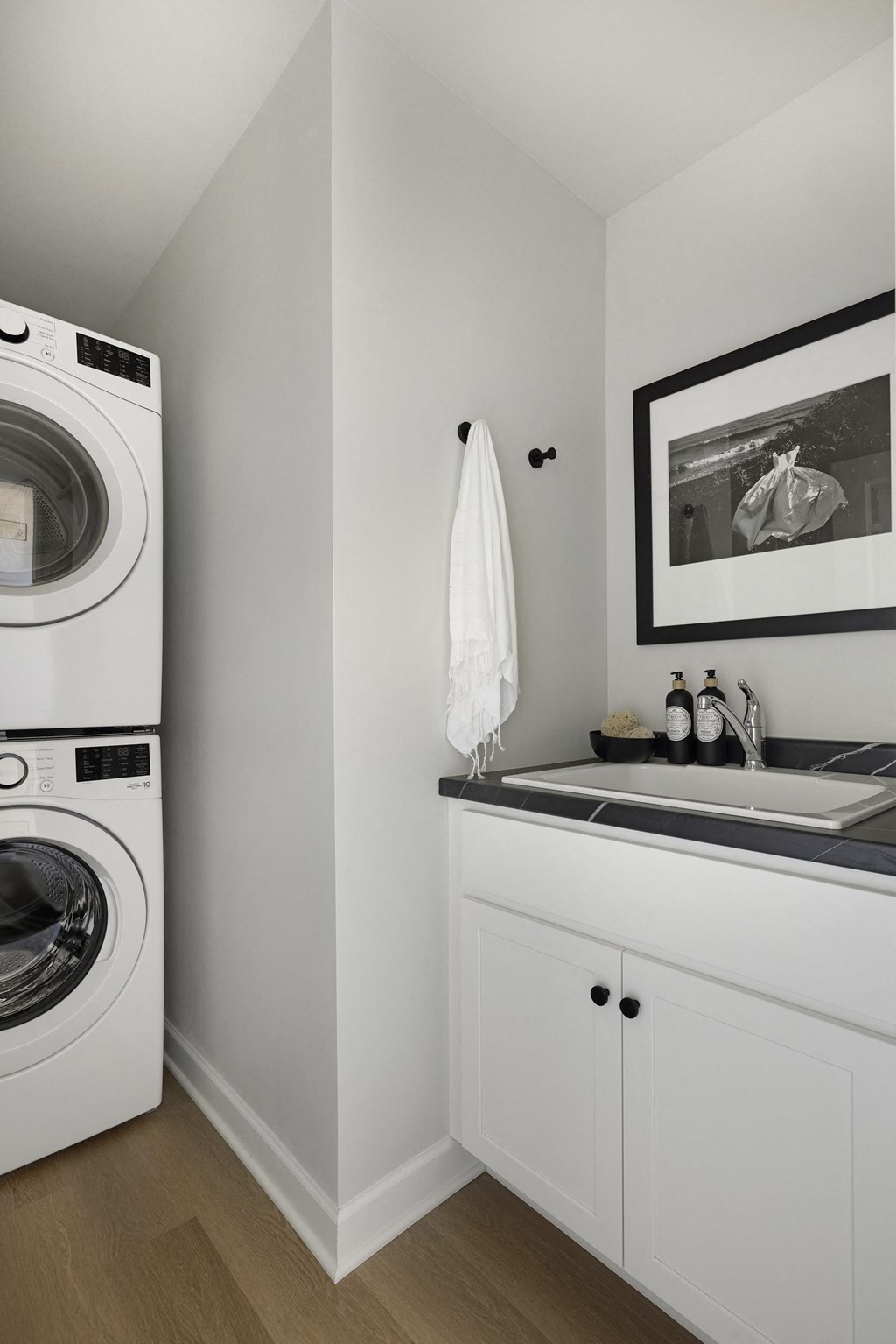 a small laundry room with a washing machine and a sink