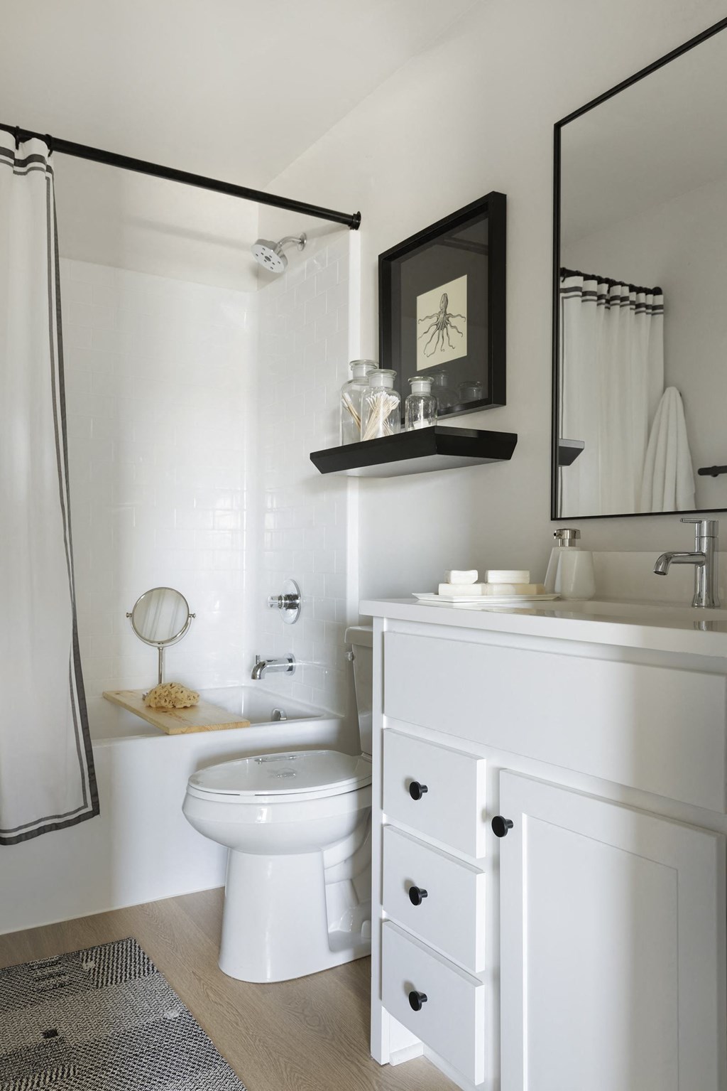 a white bathroom with a white toilet and a sink