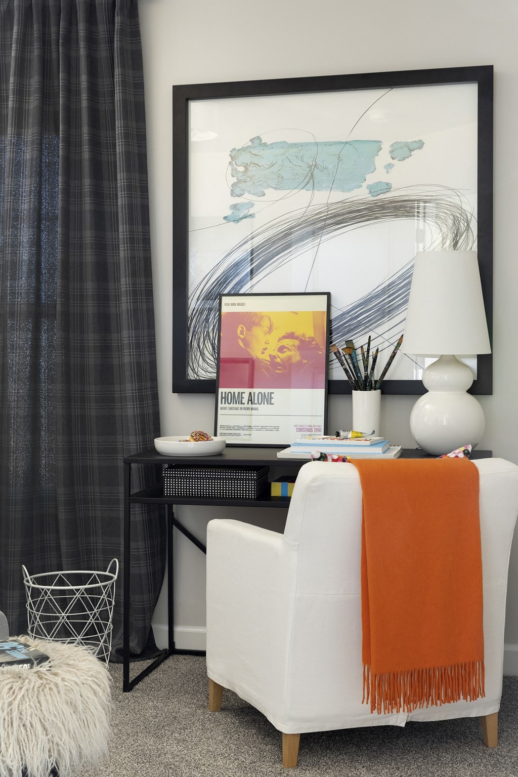 a home office with an orange and white chair and a black desk with a computer