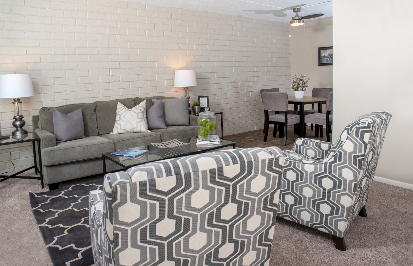 a living room with a couch and a chair and a table