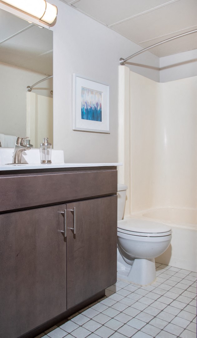 a bathroom with a toilet and a sink and a mirror