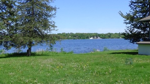 a view of the lake from the yard of a house
