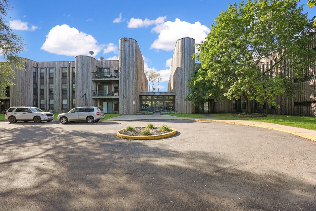 a view of the front of a building with cars parked in front of it