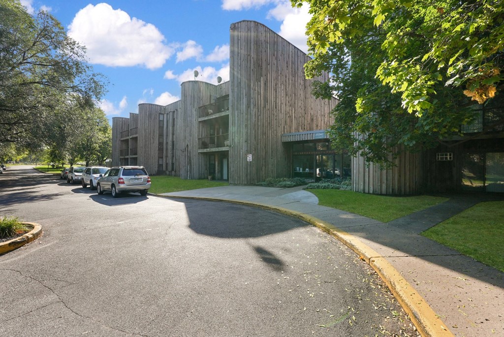 a city street with cars parked in front of a building