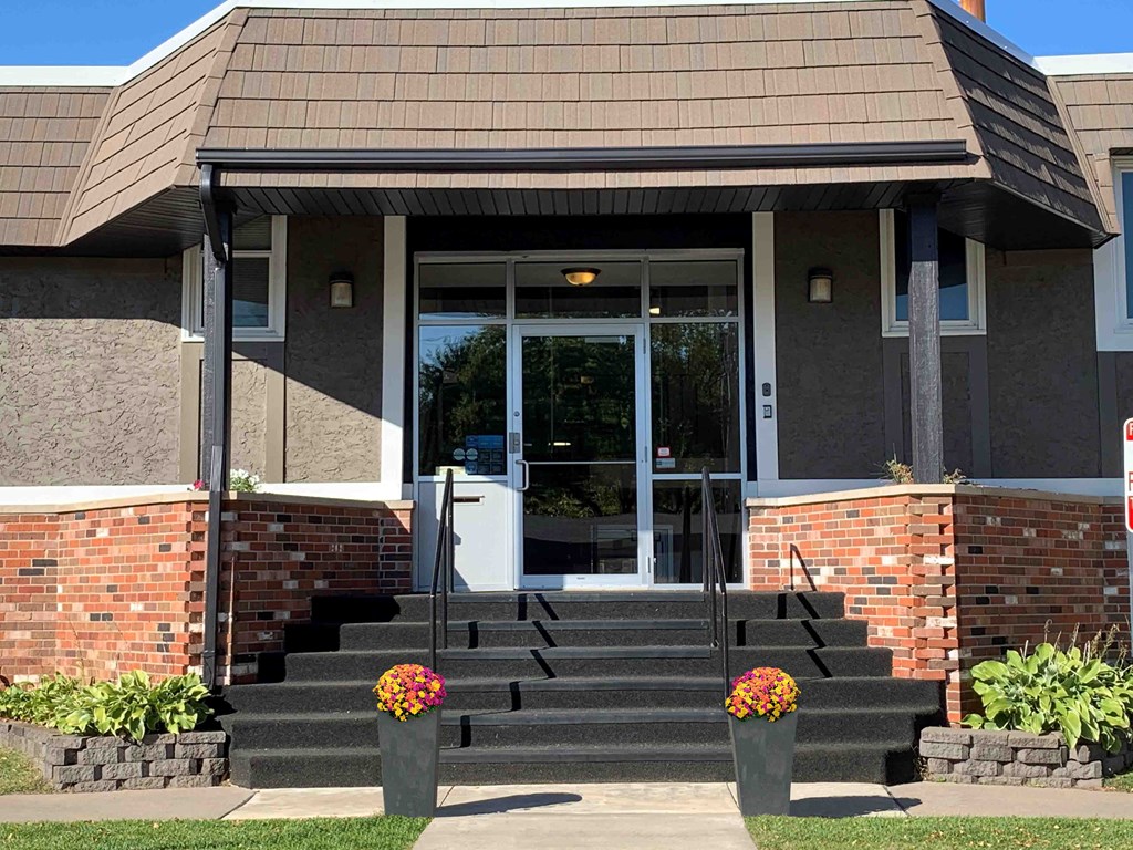 the front of a building with steps and a porch