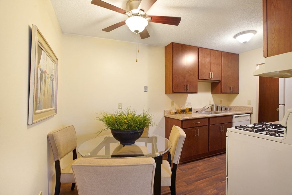 a kitchen and dining room with a table and chairs