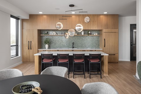 A modern kitchen with a dining table set for four.