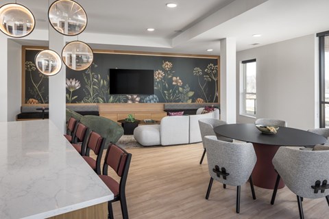 A modern dining room with a black table and chairs.