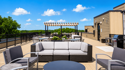 A patio with a table and chairs and a pergola.
