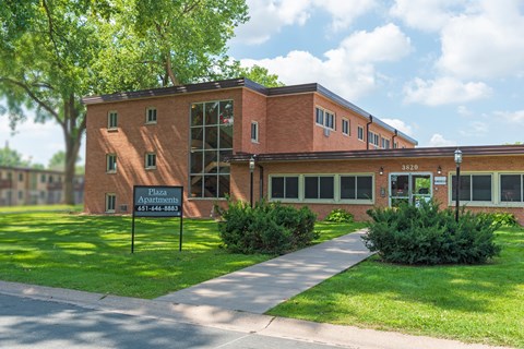 a brick building with a sign in front of it