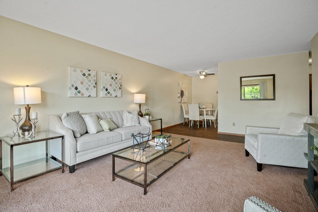 a living room with a couch and a chair at Point of America Apartments,Minnesota