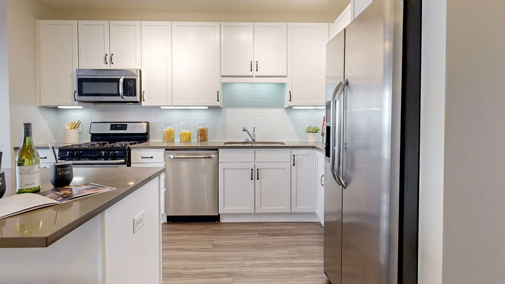 a kitchen with stainless steel appliances and white cabinets at Residences at 1700, Minnetonka, Minnesota