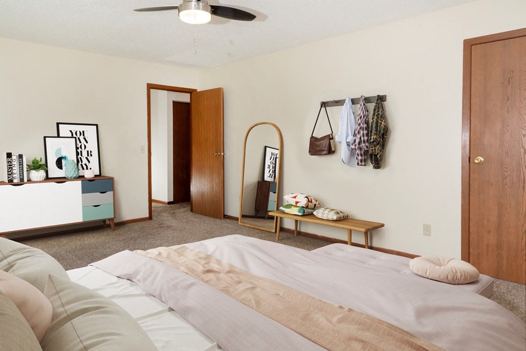 a bedroom with a bed and a dresser and a closet