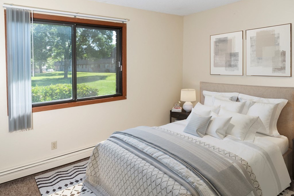 a bedroom with a large bed and a window