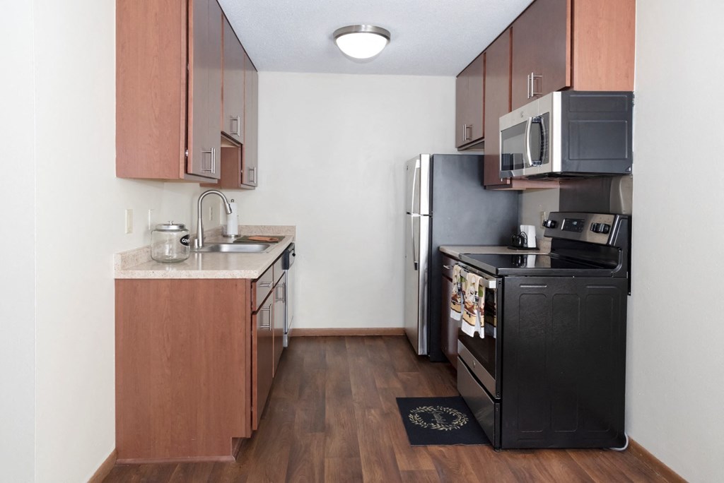 a kitchen with a stove refrigerator and a sink