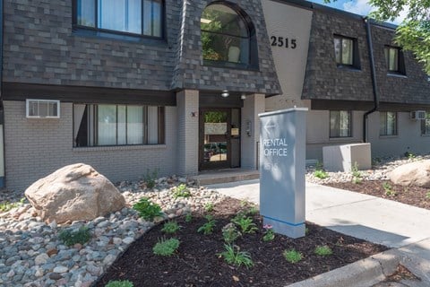 a sidewalk in front of a building with a sign that reads dental office